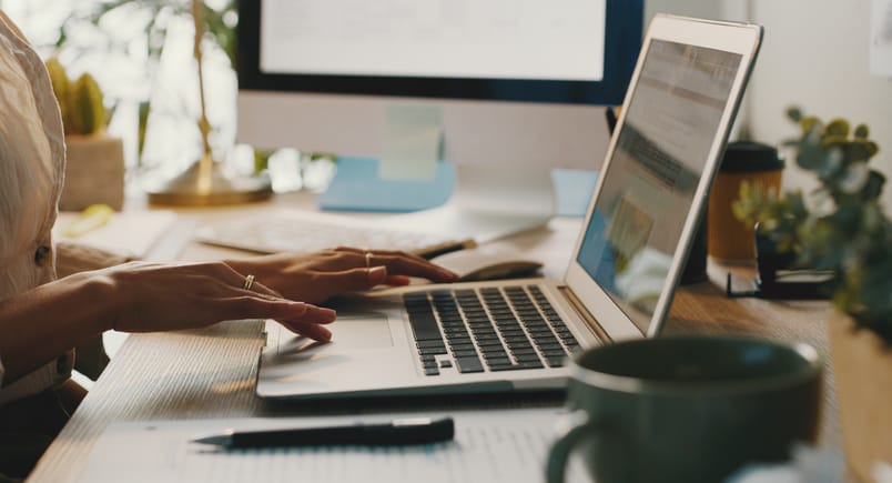 Photo shows a woman using her laptop at home/Getty Images