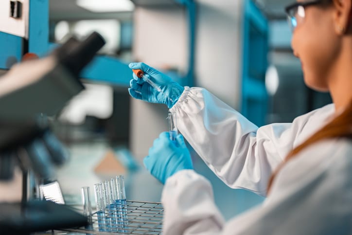 Photo shows a female scientist conducting research in a lab
