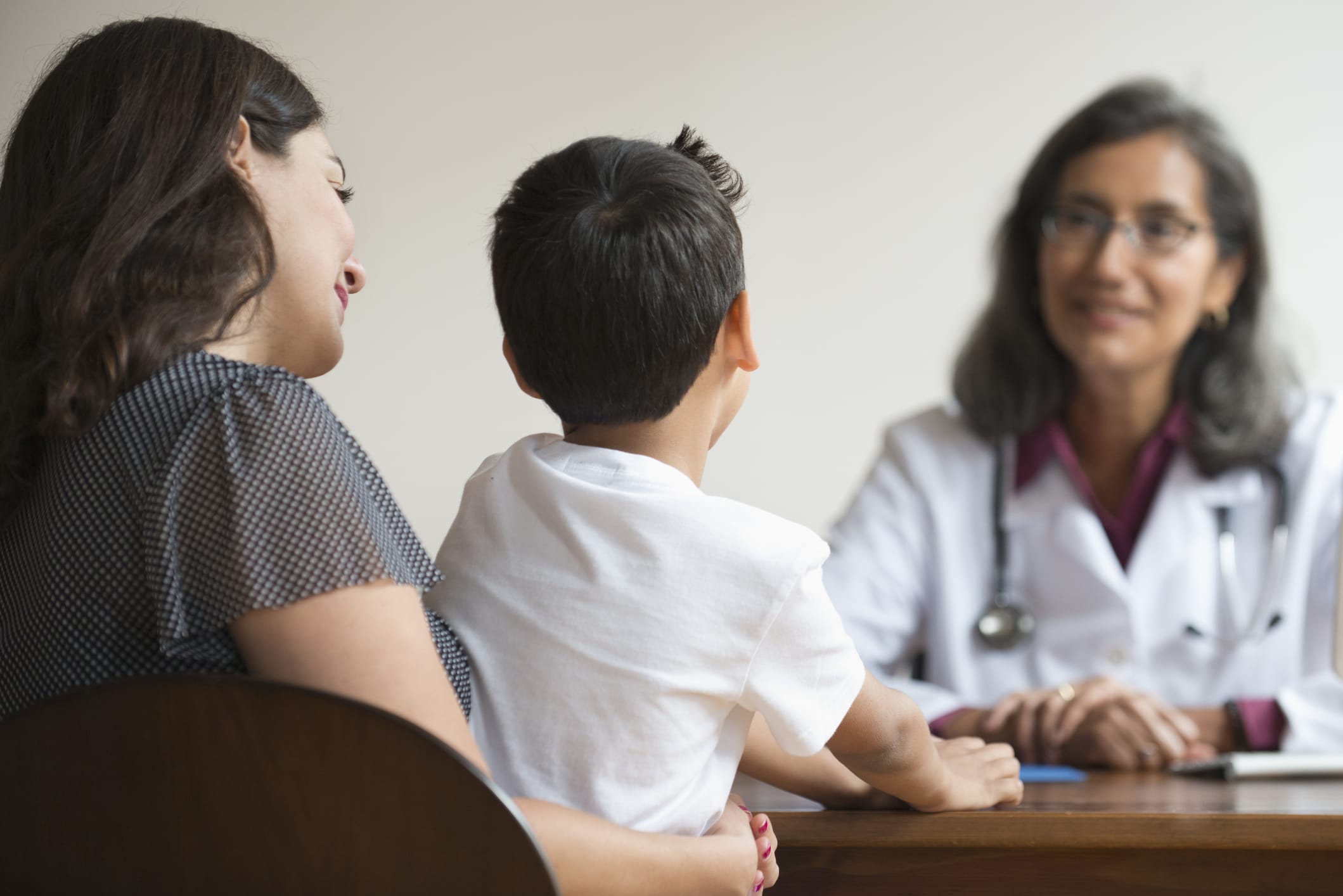 Doctor talking with mother and pediatric patient