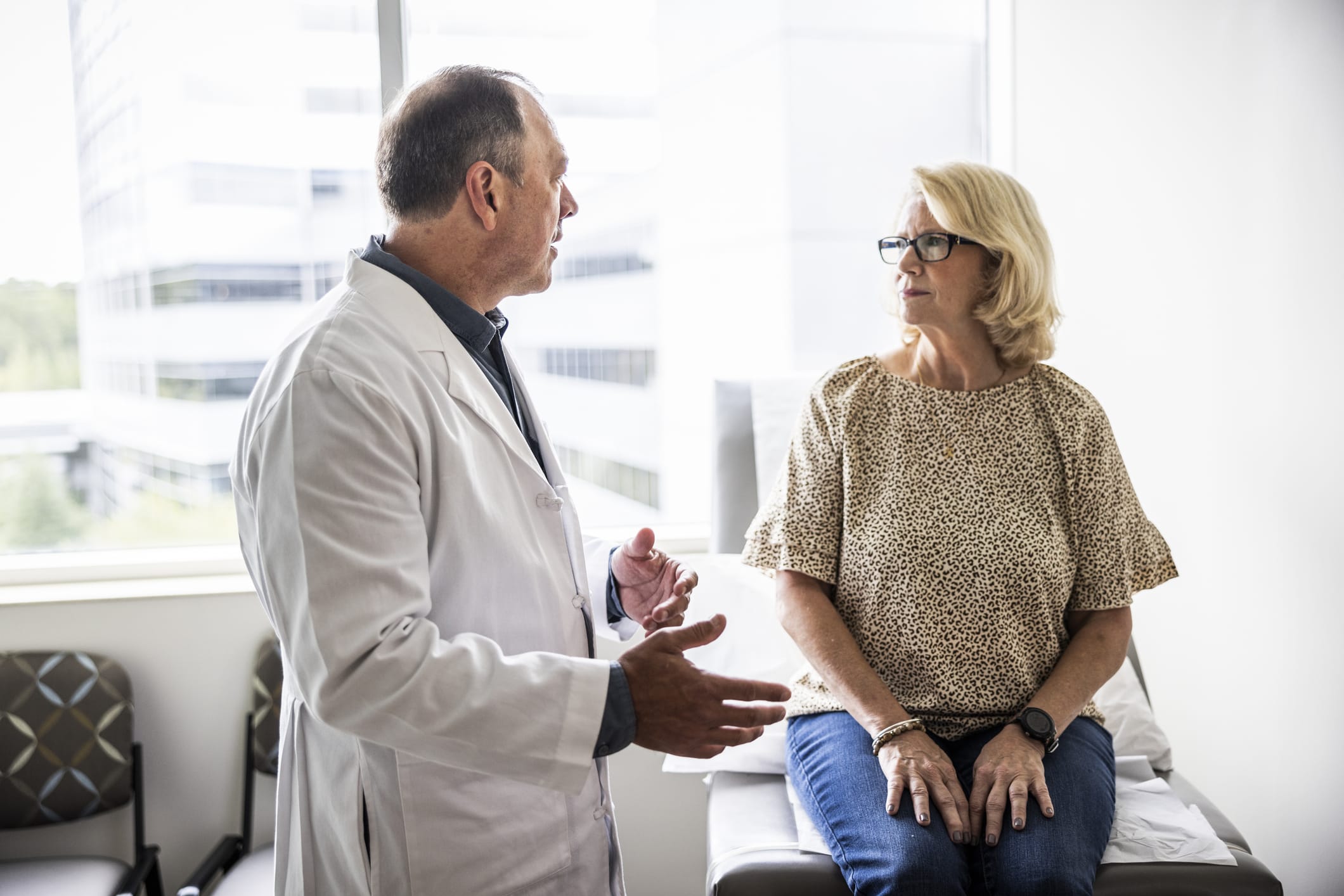 Middle-aged woman listening to her doctor during an exam