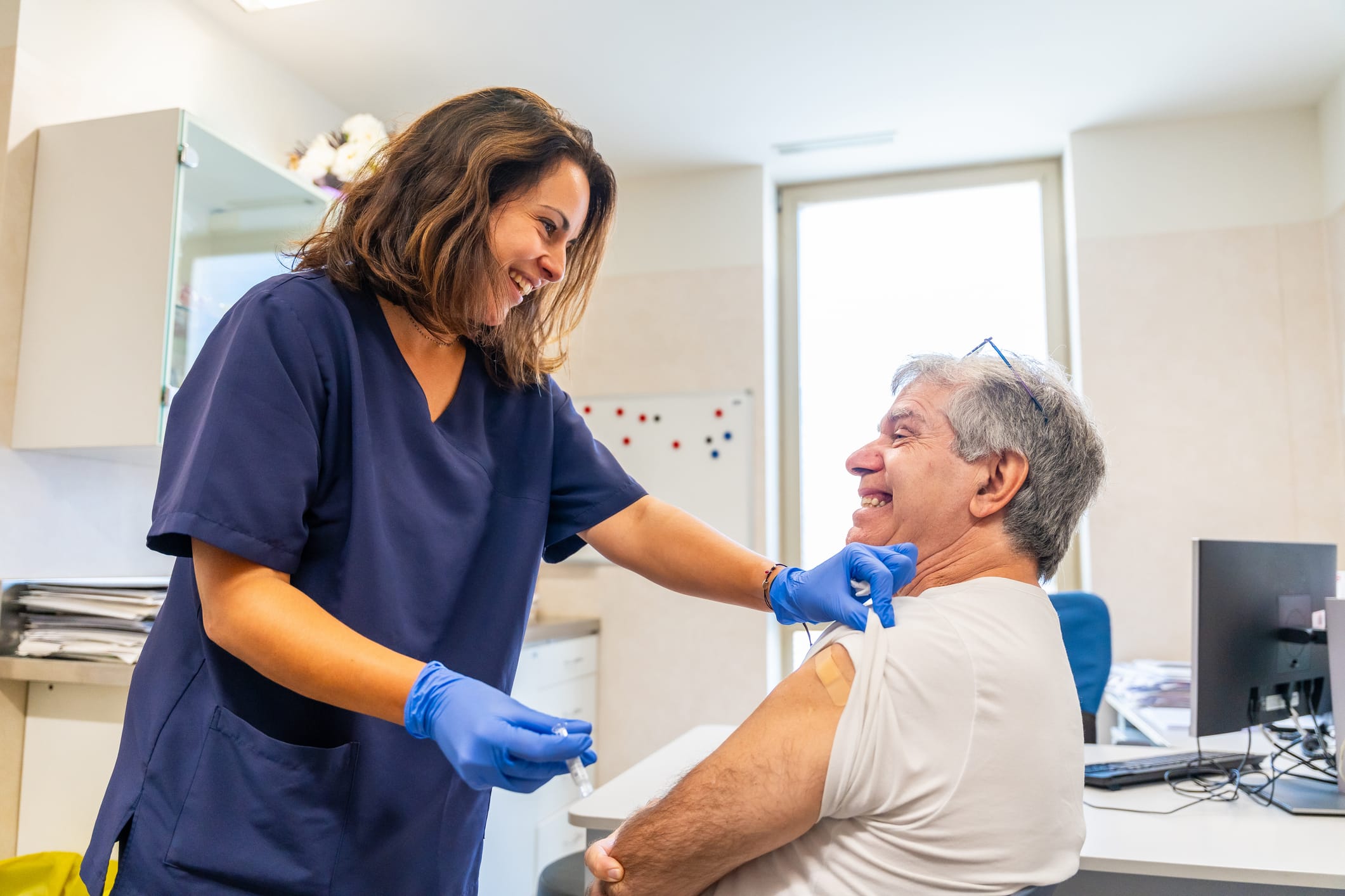 Man smiling after being given a vaccine by a healthcare provider