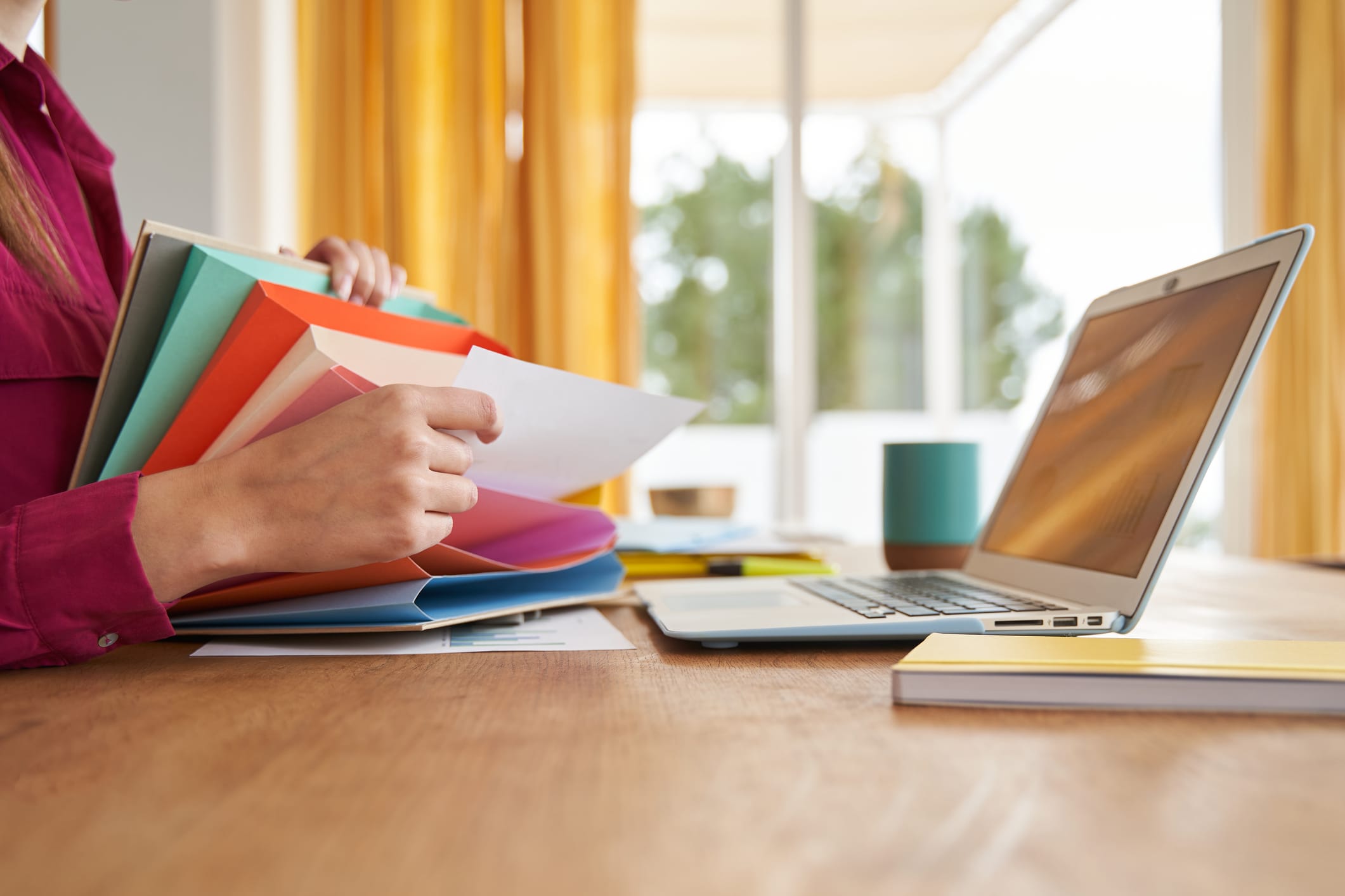 Close-up of woman organizing papers in filing system