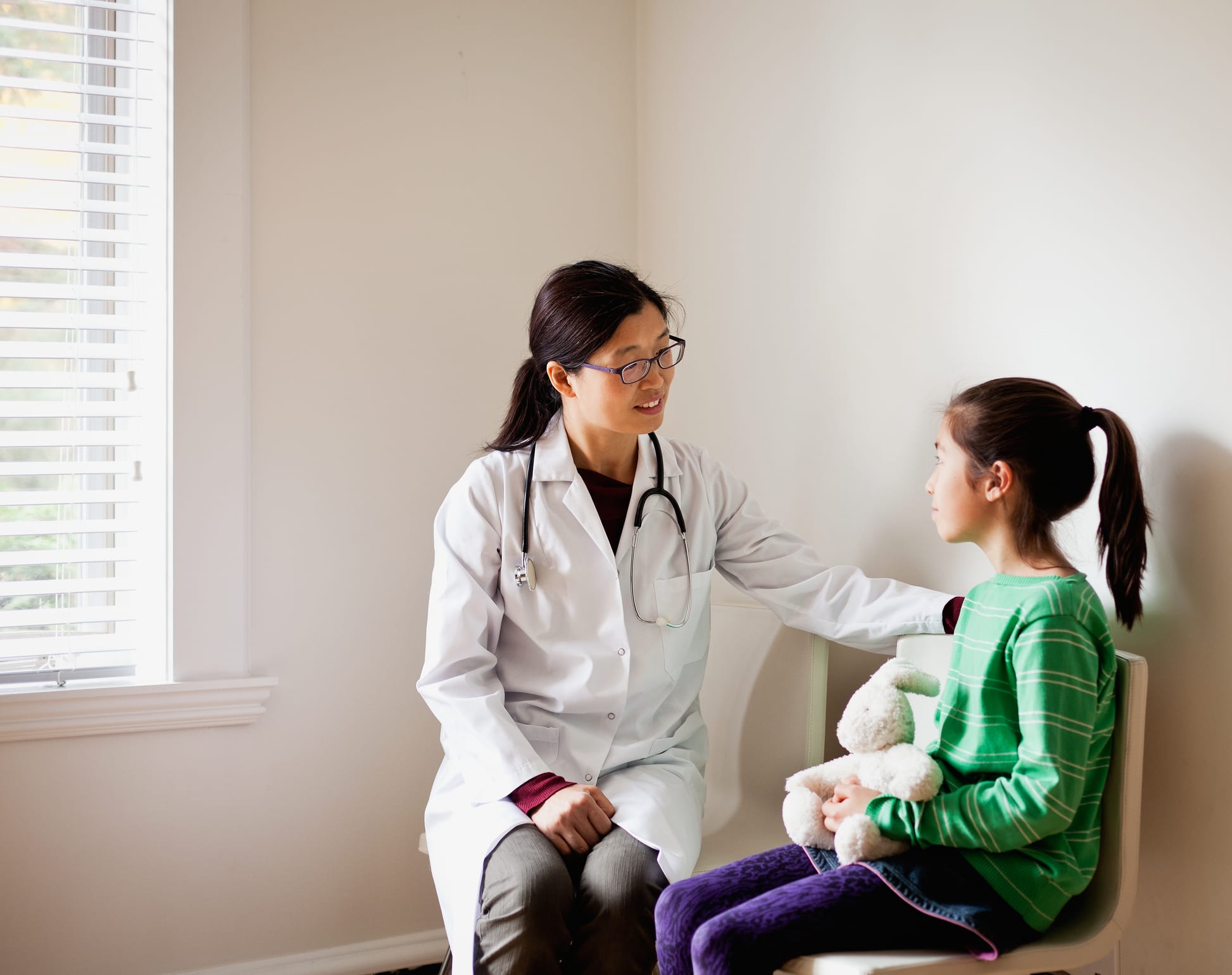 Doctor speaking to a preteen patient