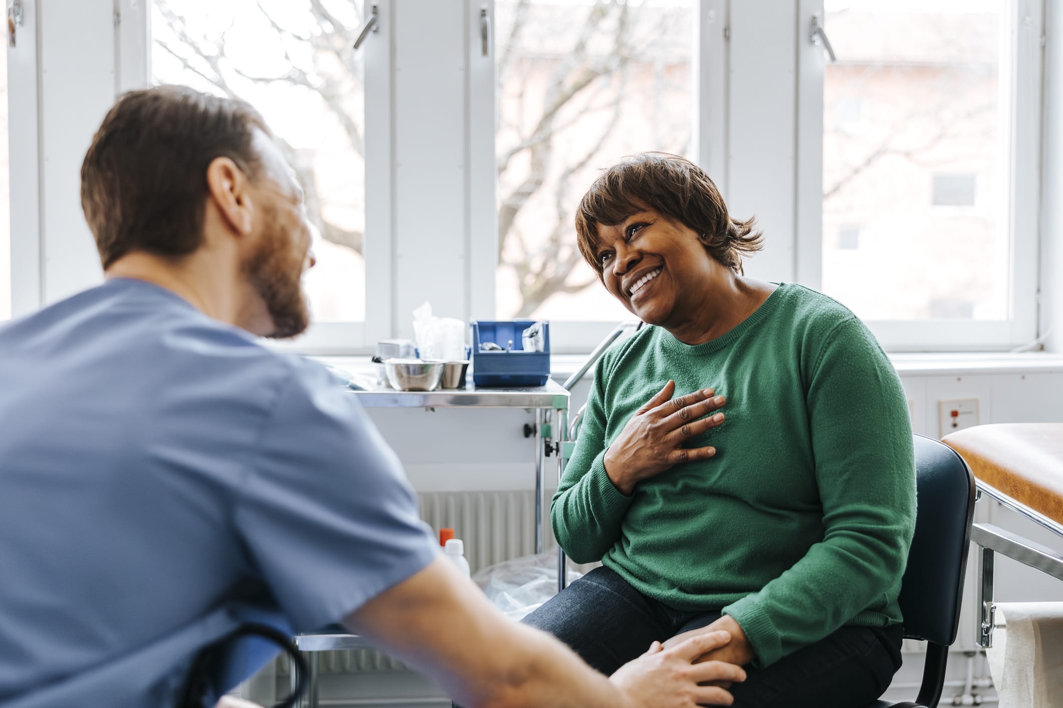 Happy woman speaking with her doctor
