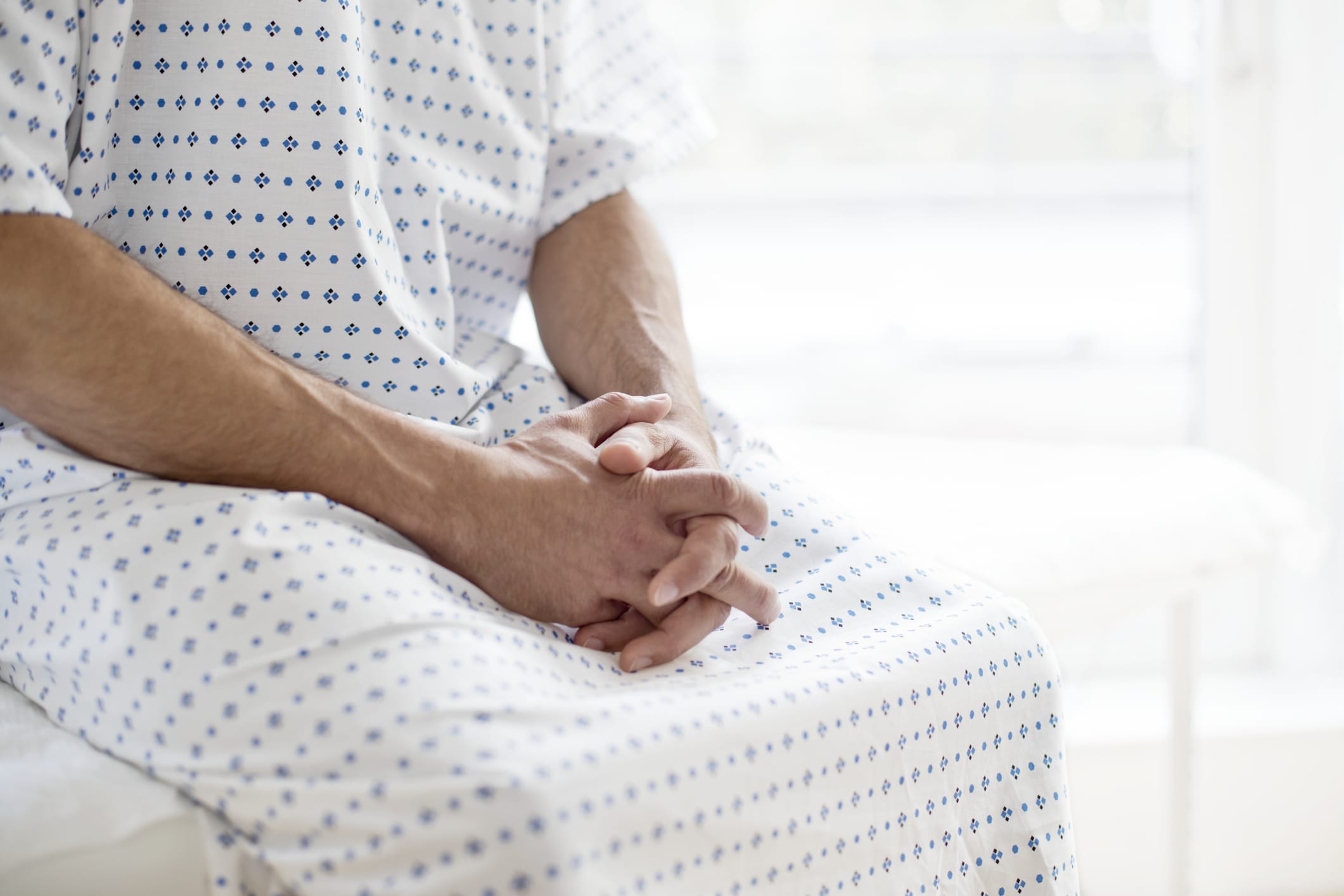 Male patient waiting in hospital gown